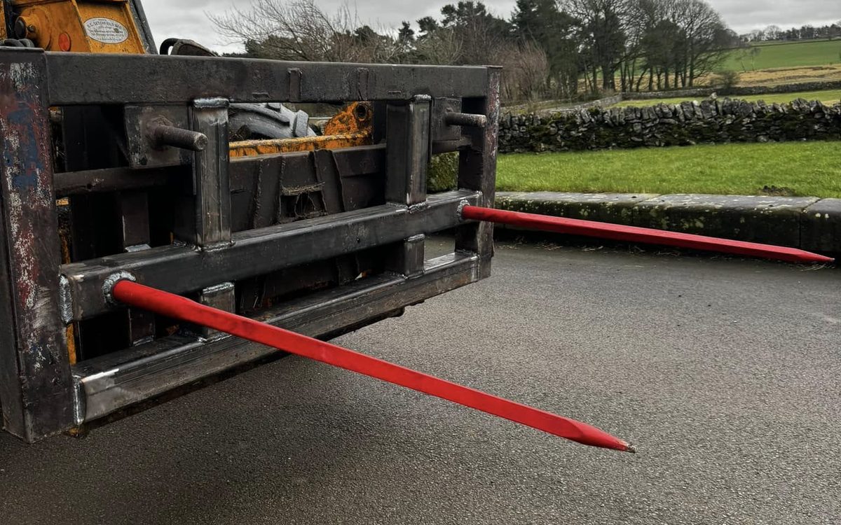 Custom-built bale spikes fabricated and fitted to a telehandler headstock