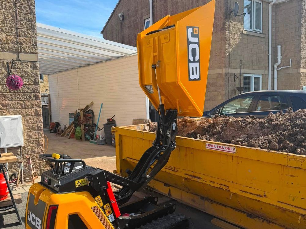 JCB HTD-5 high-tip dumper tipping spoil straight into a skip