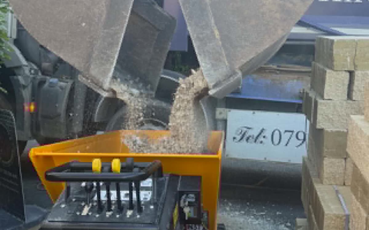 Gravel being loaded into a JCB tracked dumper on a domestic job